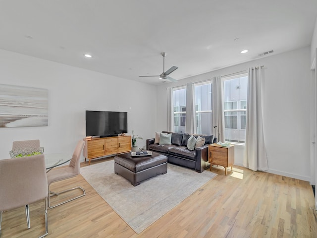 living area with recessed lighting, visible vents, and light wood-style flooring