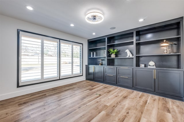 unfurnished living room with light wood-style floors, baseboards, and recessed lighting