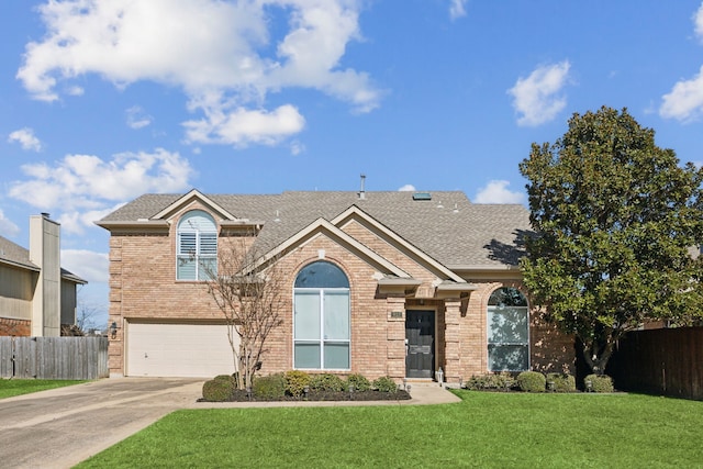 traditional home with a garage, brick siding, fence, driveway, and a front lawn