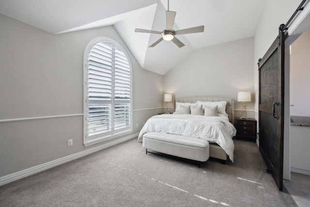 carpeted bedroom with vaulted ceiling, a barn door, a ceiling fan, and baseboards