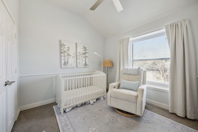 bedroom with a nursery area, baseboards, vaulted ceiling, and carpet flooring