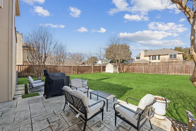 view of patio featuring a fenced backyard, a storage unit, grilling area, and an outdoor structure