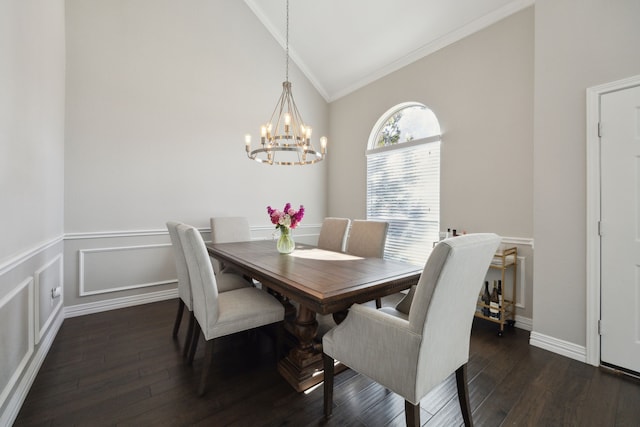 dining room featuring crown molding, vaulted ceiling, dark wood finished floors, and a decorative wall