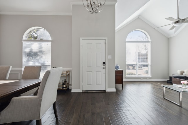 dining room with dark wood-style flooring, plenty of natural light, and ceiling fan with notable chandelier