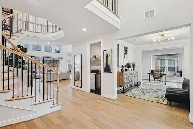 2840 Killdeer Trl, Prosper, TX 75078 - foyer with wood finished floors, stairway, a towering ceiling, ornamental molding, and a chandelier