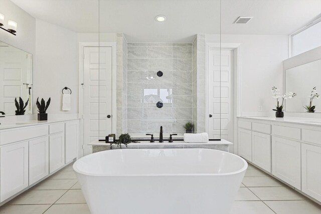 2840 Killdeer Trl, Prosper, TX 75078 - bathroom featuring two vanities, tile patterned floors, a soaking tub, recessed lighting, and tiled shower