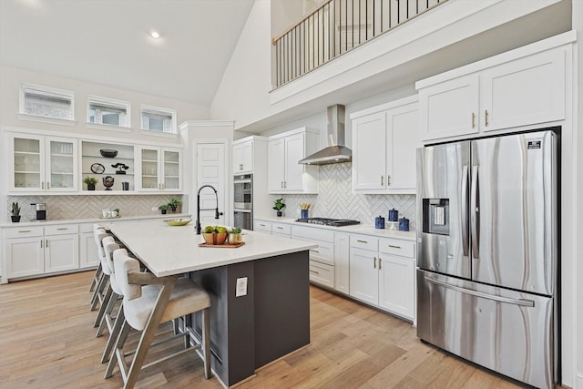 2840 Killdeer Trl, Prosper, TX 75078 - kitchen with stainless steel appliances, wall chimney exhaust hood, open shelves, high vaulted ceiling, and backsplash