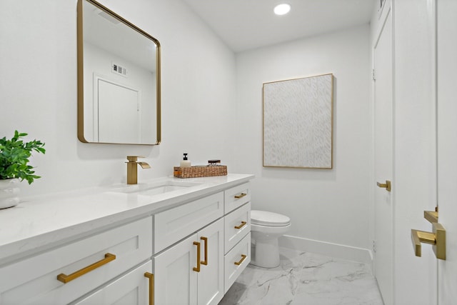 bathroom featuring toilet, visible vents, vanity, baseboards, and marble finish floor