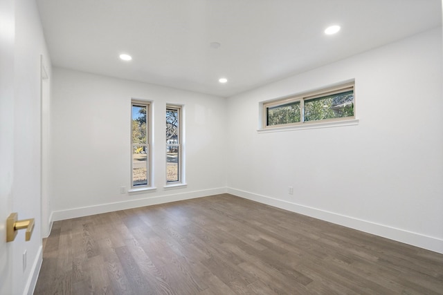 unfurnished room featuring baseboards, dark wood-style flooring, and recessed lighting