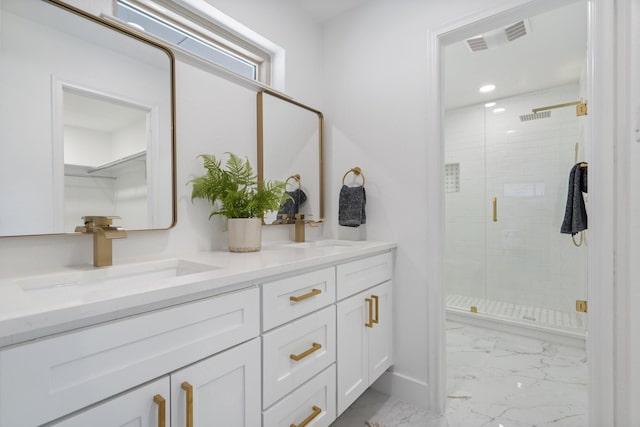 bathroom featuring a stall shower, marble finish floor, visible vents, and a sink