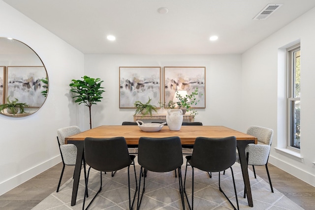 dining space featuring baseboards, visible vents, wood finished floors, and recessed lighting