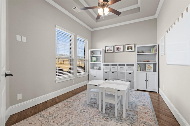 game room with a raised ceiling, visible vents, ornamental molding, wood finished floors, and baseboards