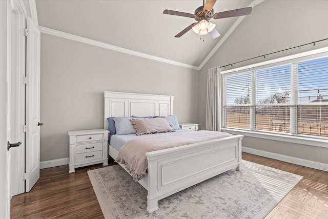 bedroom with vaulted ceiling, crown molding, dark wood finished floors, and baseboards