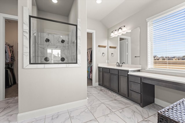 full bath with a walk in closet, marble finish floor, baseboards, and a walk in shower