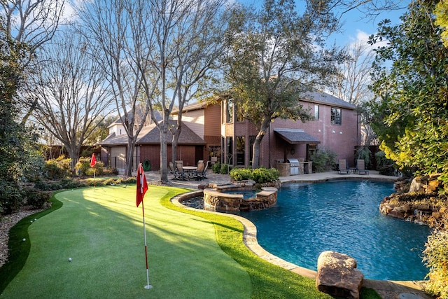 view of swimming pool featuring a patio area, a pool with connected hot tub, and fence