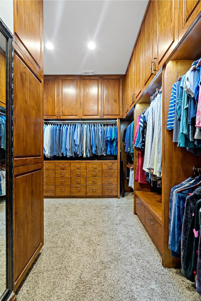 walk in closet with visible vents and carpet flooring