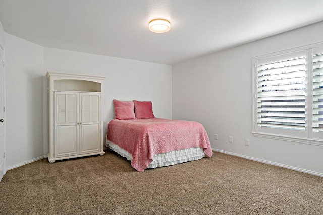 bedroom featuring carpet floors and baseboards