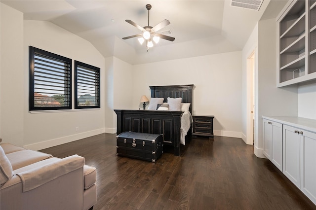 bedroom featuring visible vents, dark wood-type flooring, vaulted ceiling, ceiling fan, and baseboards