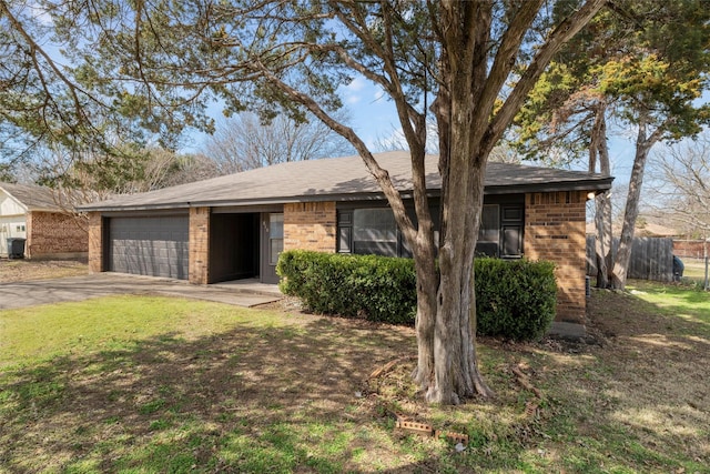 single story home featuring a garage, driveway, fence, and brick siding