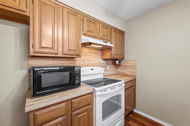 kitchen with white electric range oven, baseboards, butcher block counters, under cabinet range hood, and black microwave