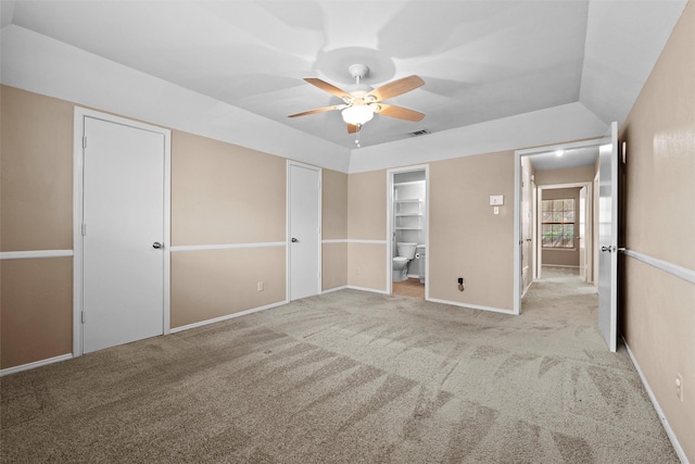 unfurnished bedroom with baseboards, visible vents, a ceiling fan, lofted ceiling, and carpet flooring