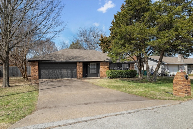 view of front facade with a garage, brick siding, fence, concrete driveway, and a front yard