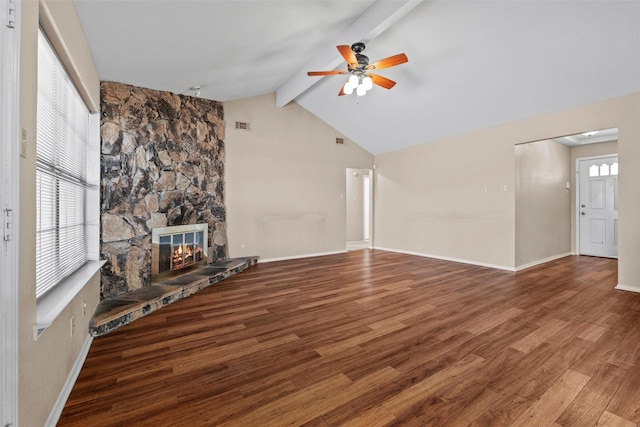 unfurnished living room featuring a wealth of natural light, a fireplace, and wood finished floors