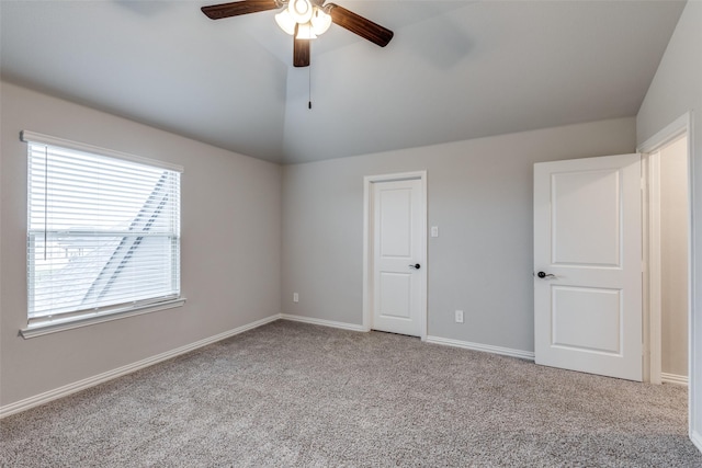 unfurnished bedroom featuring ceiling fan, baseboards, carpet, and vaulted ceiling