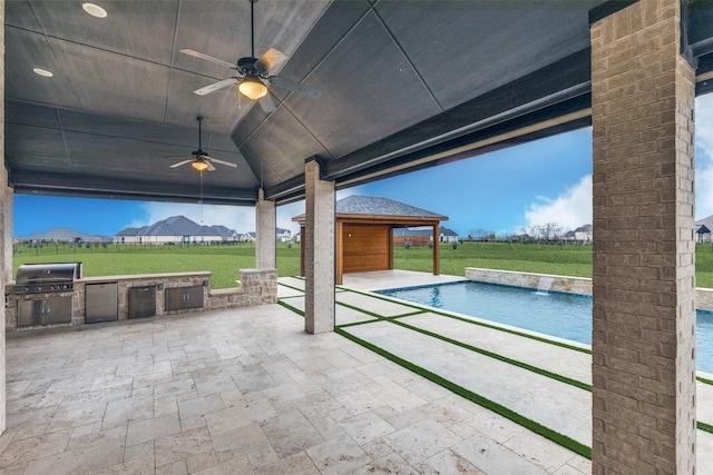 exterior space featuring an outdoor pool, area for grilling, exterior kitchen, and ceiling fan