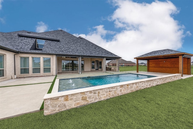 pool with a patio, a lawn, and fence