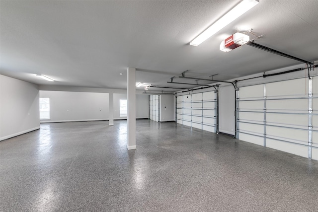 garage featuring baseboards and a garage door opener