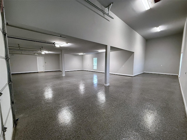 garage featuring a garage door opener and baseboards