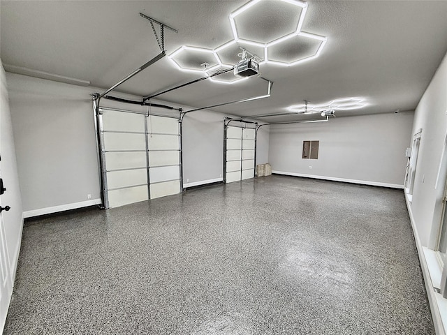 garage featuring electric panel and baseboards