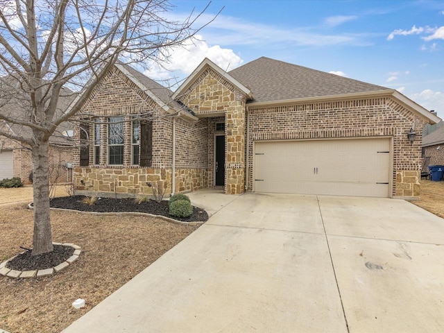 view of front facade with a garage, brick siding, stone siding, concrete driveway, and roof with shingles