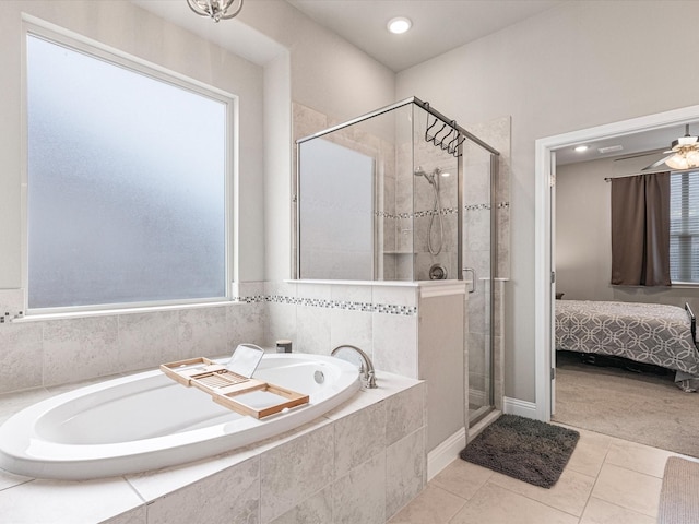 bathroom with a garden tub, tile patterned flooring, a ceiling fan, a shower stall, and ensuite bath