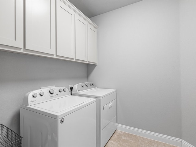 laundry room with independent washer and dryer, cabinet space, and baseboards