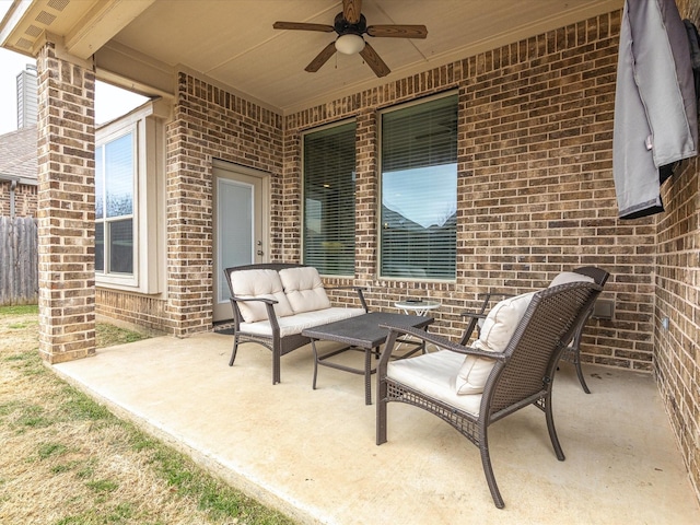 view of patio with ceiling fan, fence, and an outdoor living space