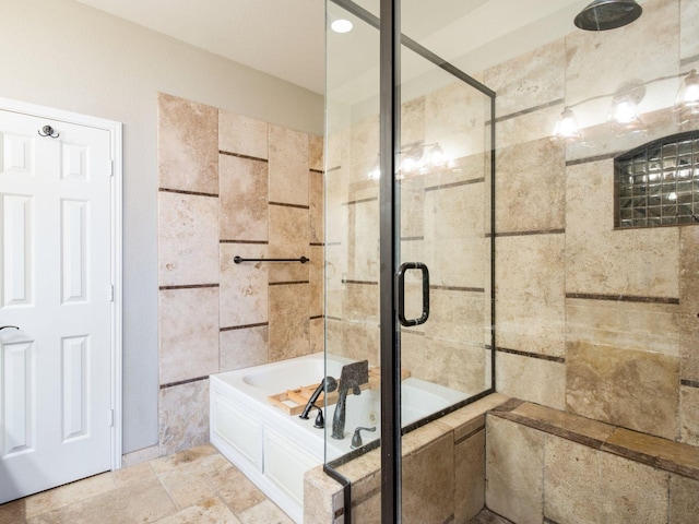 bathroom featuring stone tile floors and tiled shower / bath