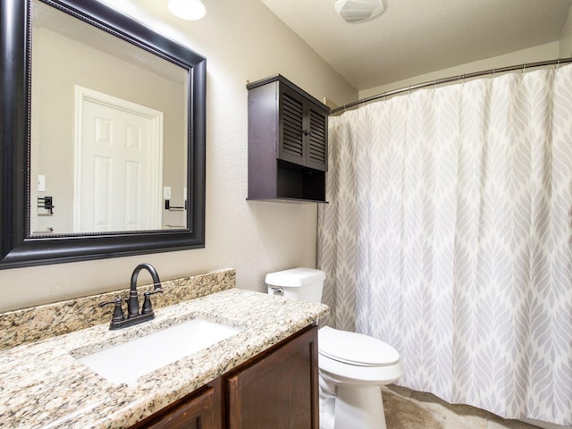 full bathroom with toilet, vanity, and a shower with curtain