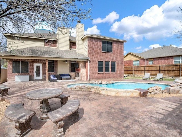 view of swimming pool featuring a ceiling fan, fence, outdoor lounge area, a fenced in pool, and a patio area