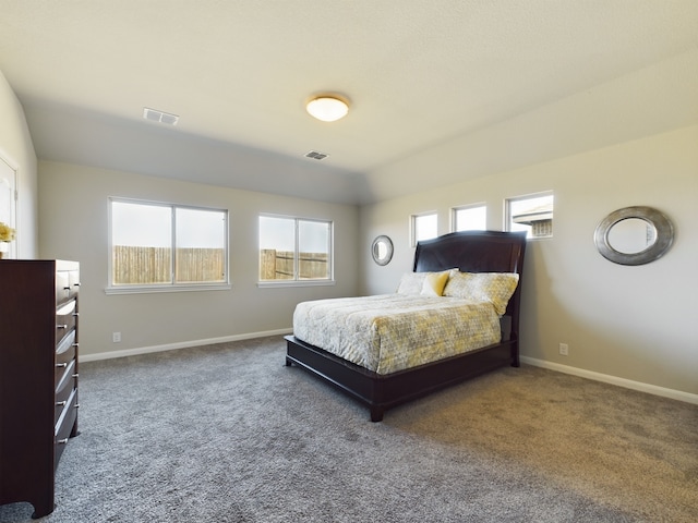 carpeted bedroom with baseboards, multiple windows, and visible vents