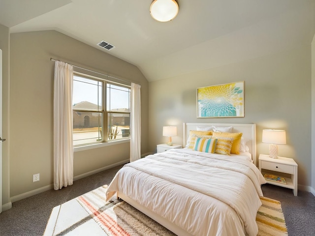 bedroom featuring lofted ceiling, baseboards, visible vents, and dark colored carpet