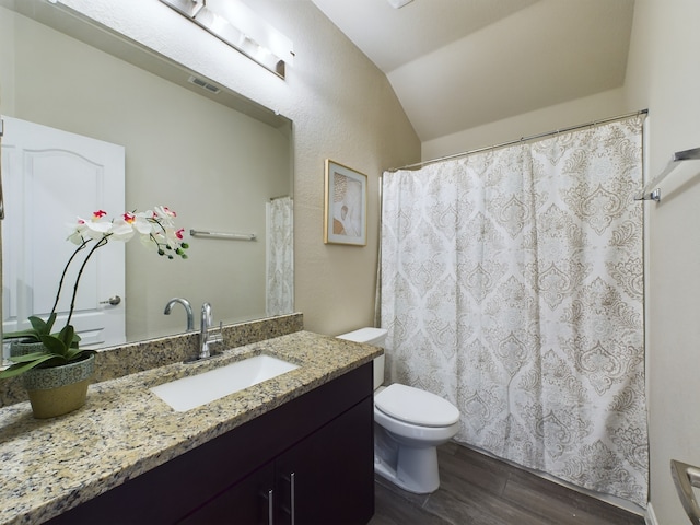 full bath featuring visible vents, toilet, lofted ceiling, wood finished floors, and vanity