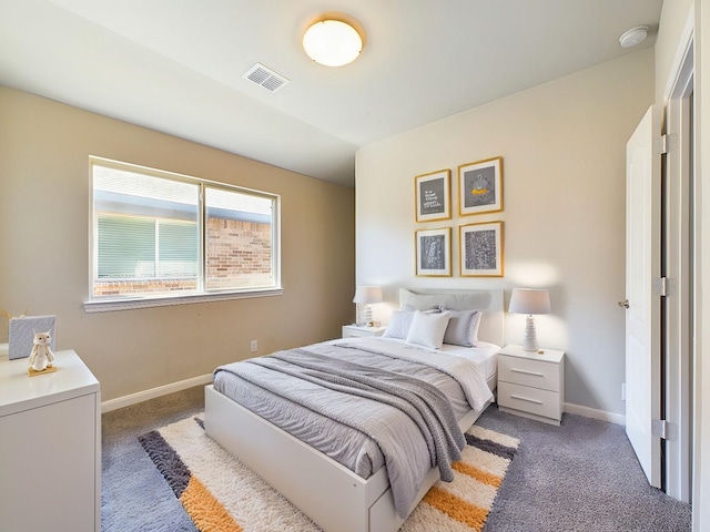 bedroom with dark colored carpet, visible vents, and baseboards