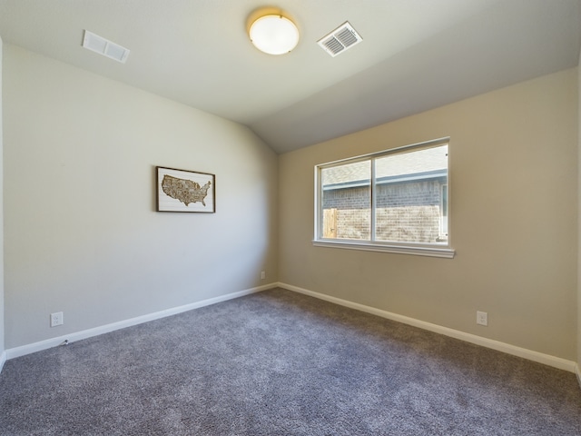 carpeted spare room with lofted ceiling, visible vents, and baseboards