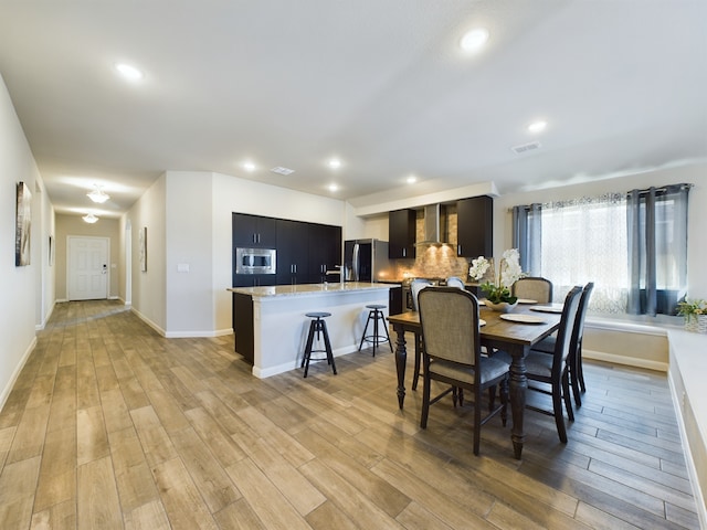 dining area with recessed lighting, visible vents, and light wood-style flooring