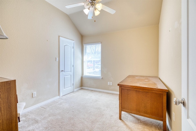 home office featuring vaulted ceiling, ceiling fan, light carpet, and baseboards