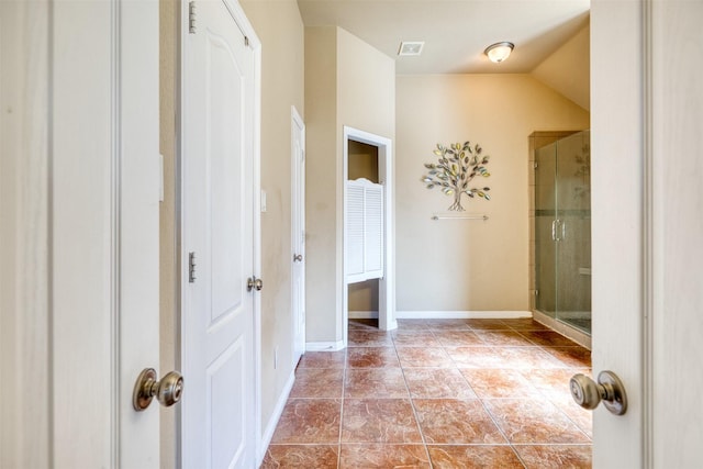 bathroom featuring a shower stall, visible vents, baseboards, and tile patterned flooring