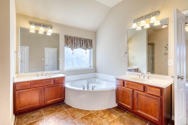 bathroom with lofted ceiling, two vanities, and a sink