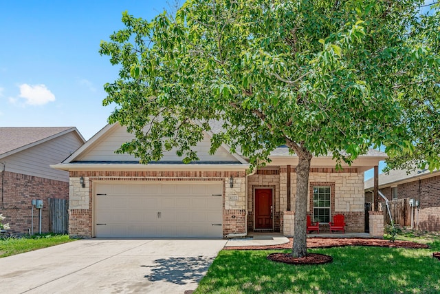 view of front of home featuring a garage, a front yard, concrete driveway, and brick siding